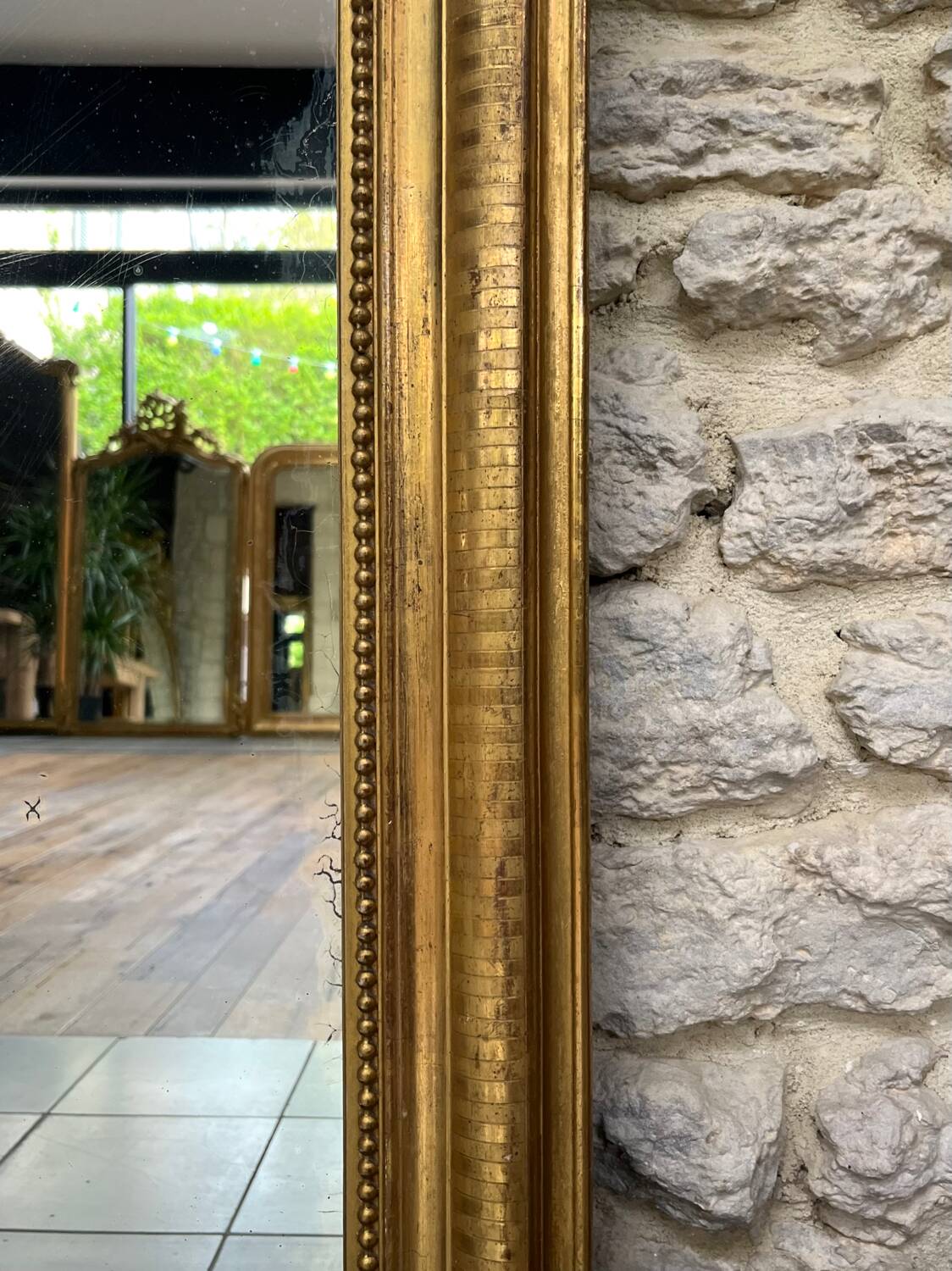 Louis-Philippe mantel mirror 133cm/115.5cm beaded gilded with gold leaf geometric decoration, late 19th century, heavily pitted and scratched glass, parquet on the back.