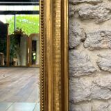 Louis-Philippe mantel mirror 133cm/115.5cm beaded gilded with gold leaf geometric decoration, late 19th century, heavily pitted and scratched glass, parquet on the back.