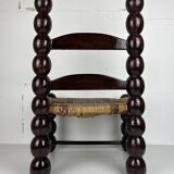 Brutalist wood turned bobbin low rush chair n the style of Charles Dudouyt