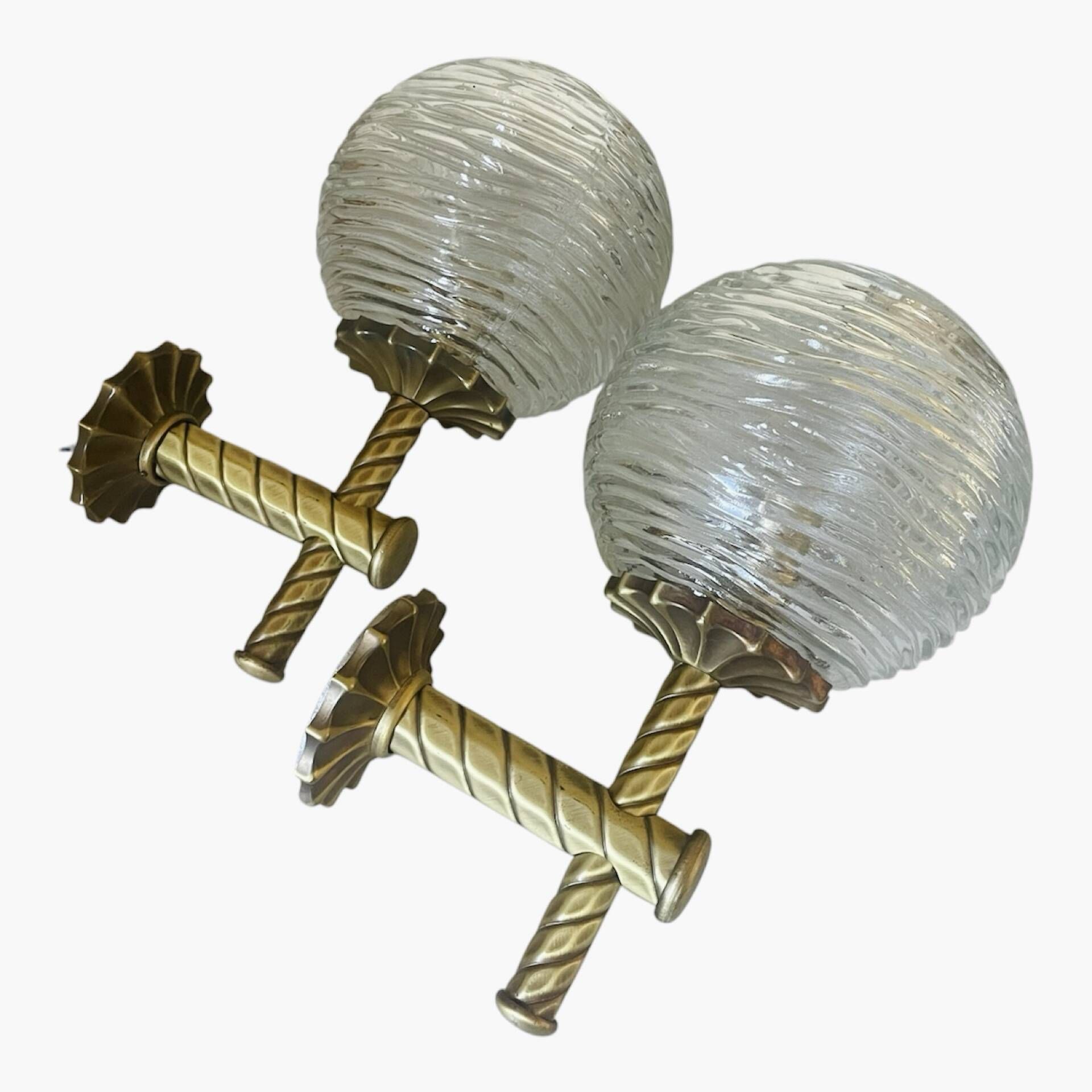 Pair of neoclassical wall sconces in twisted brass and ribbed glass.