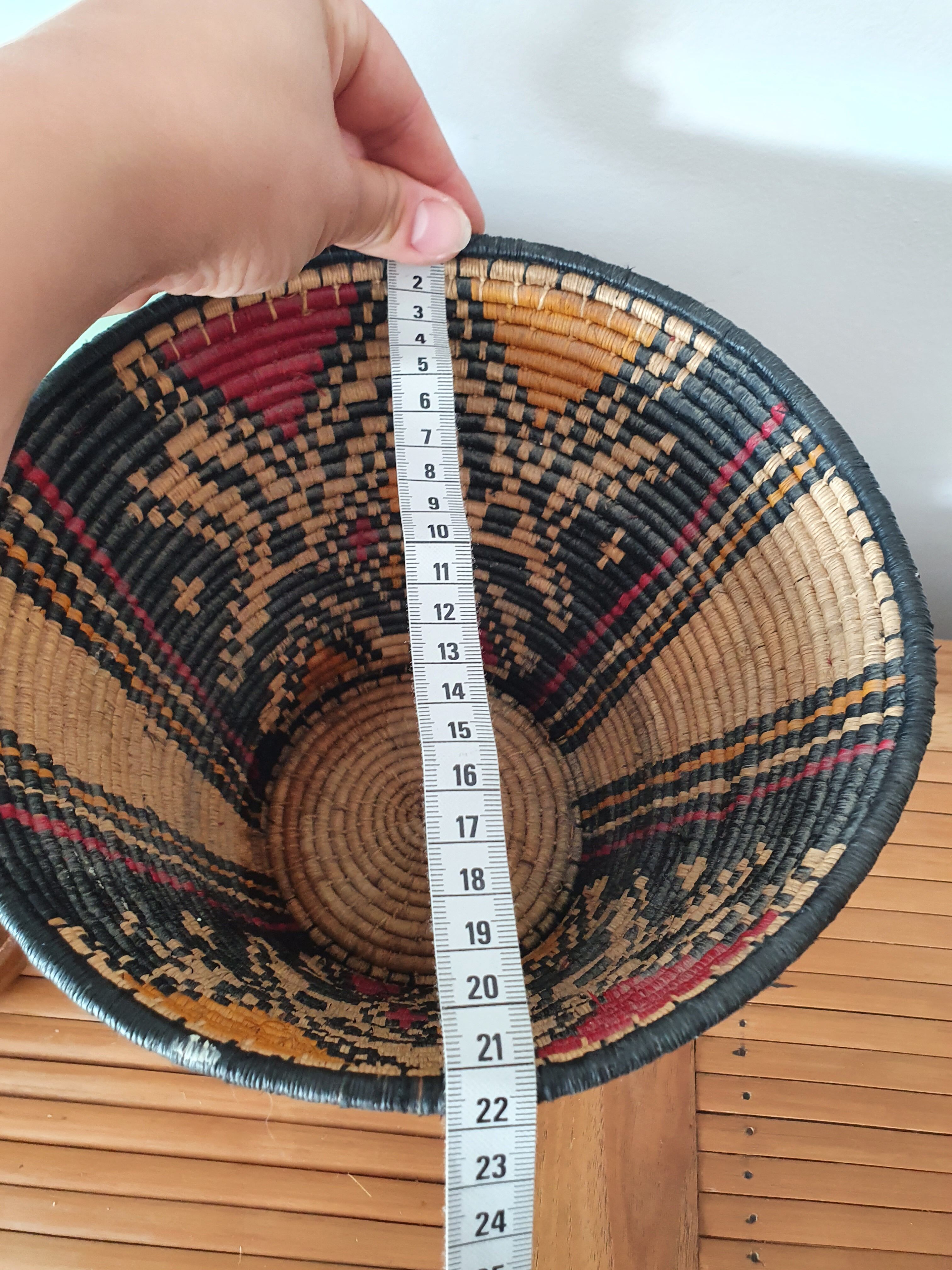 Ethnic basket in multicolored braided straw