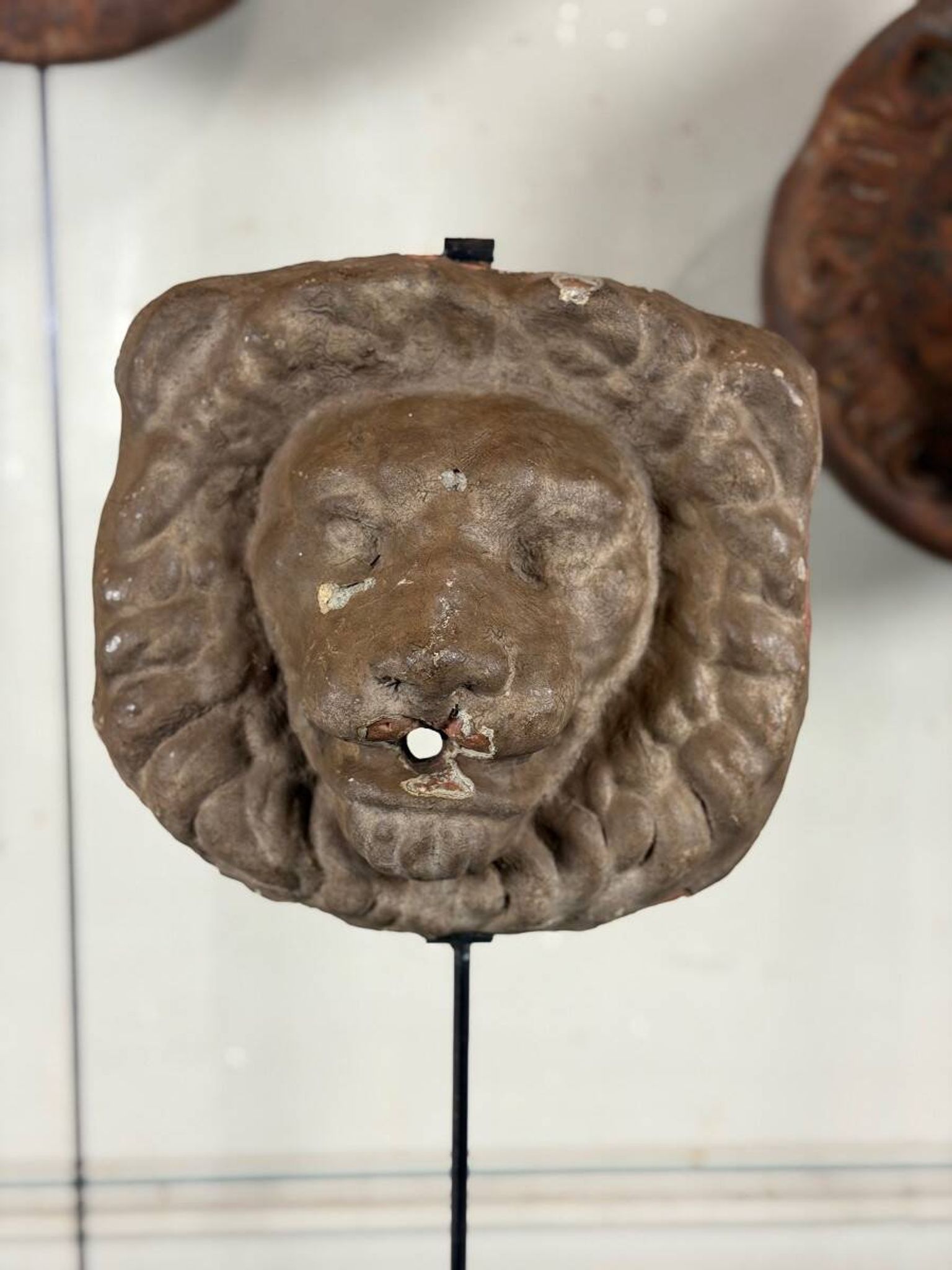 Three cast-iron and terracotta façade decoration lions, around 1880.