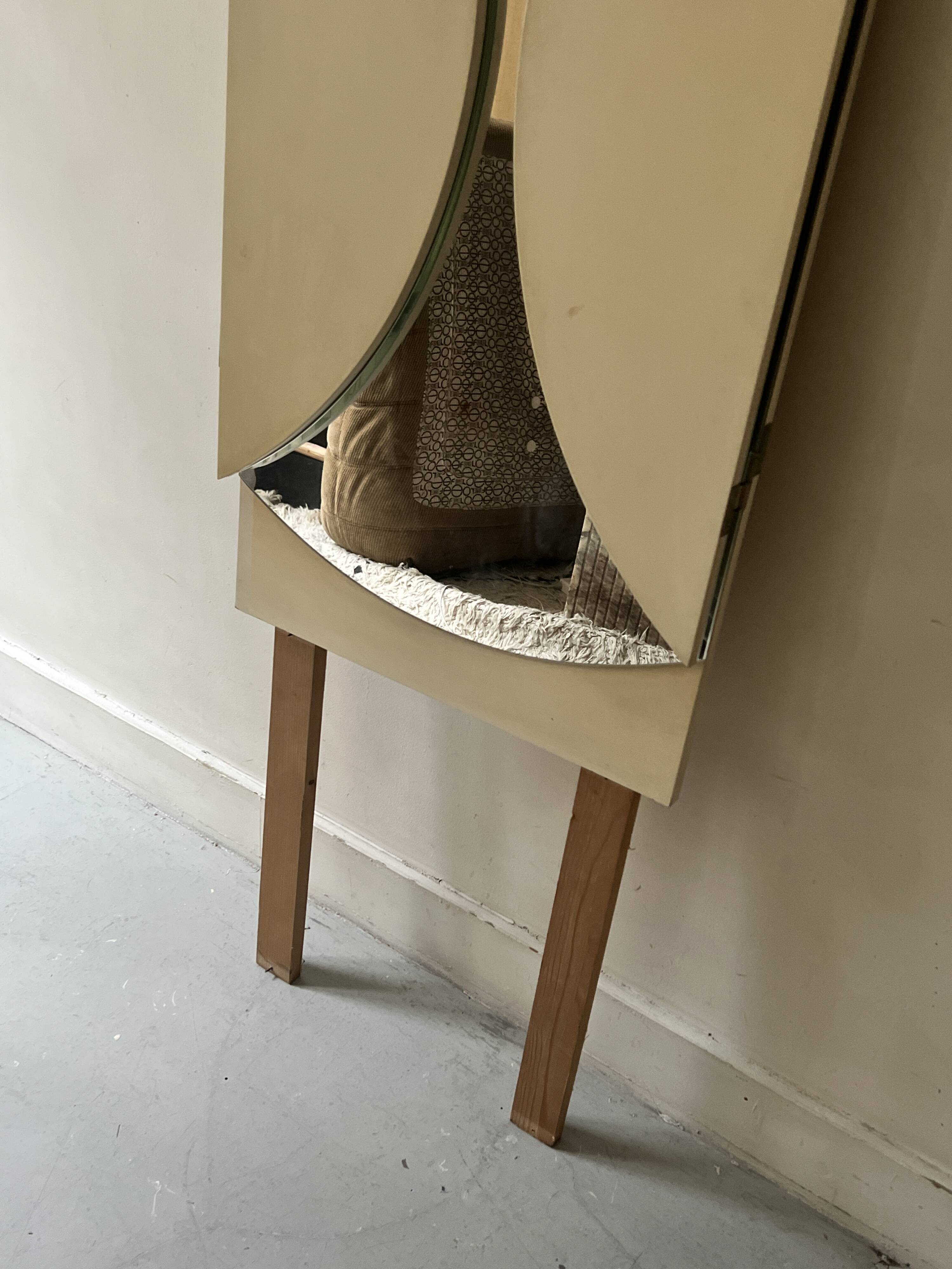 Large round triptych mirror with ivory background and back, 1970s design.