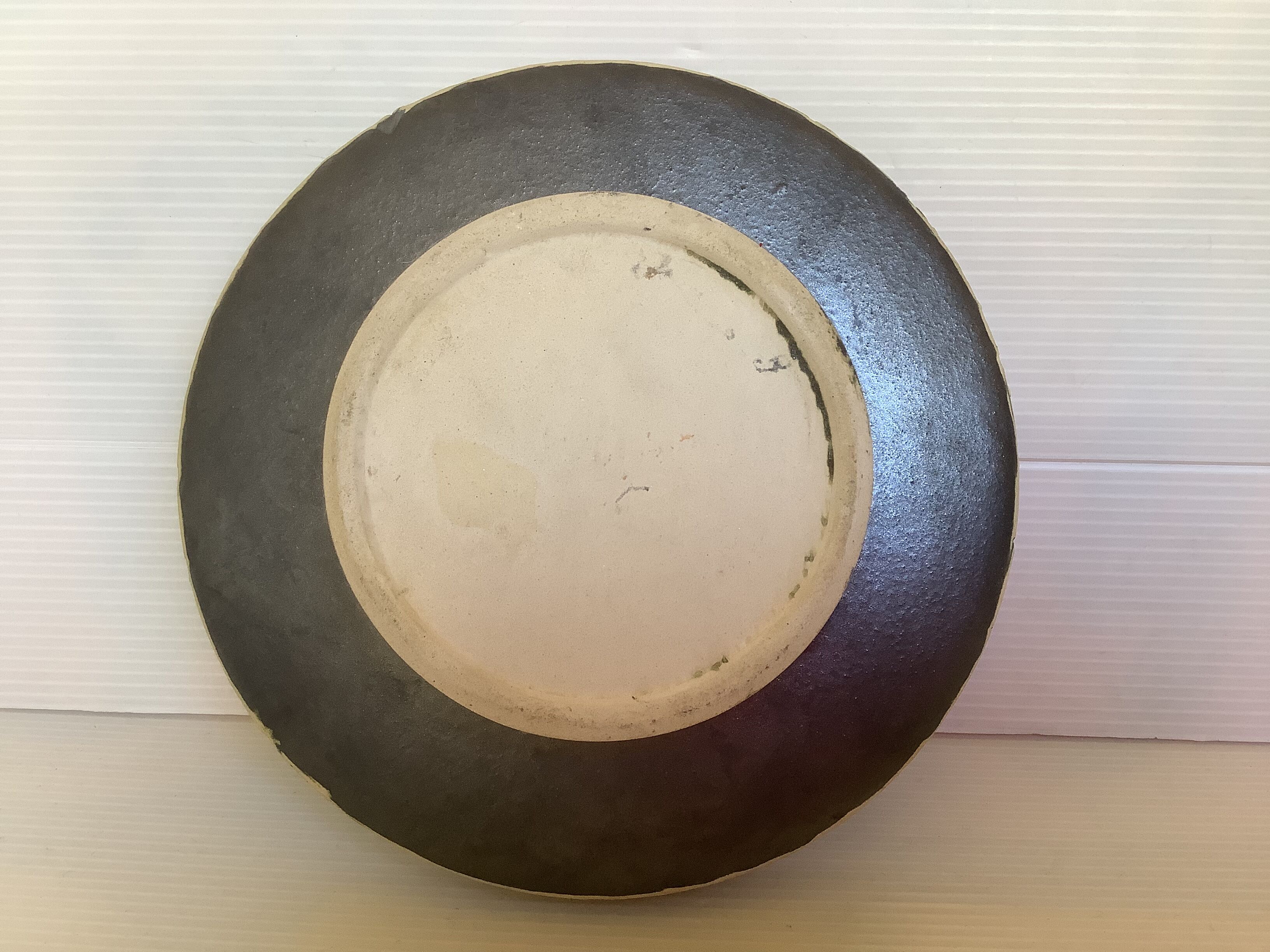 Green ceramic candle holder with a frieze