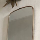 Vintage 1960s mirror in a freeform shape with a gold and red trim.