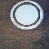 Round mirror bordered with copper