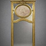Very large mirror with mouldings, richly carved and gilded, in the Louis XVI style.
