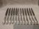 12 silver-plated table knives by Christofle Vendôme, 24.6cm
