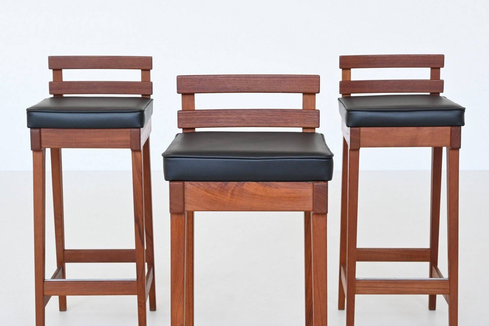 Erik Buck set of three bar stools in teak and leather Dyrlund Denmark 1960