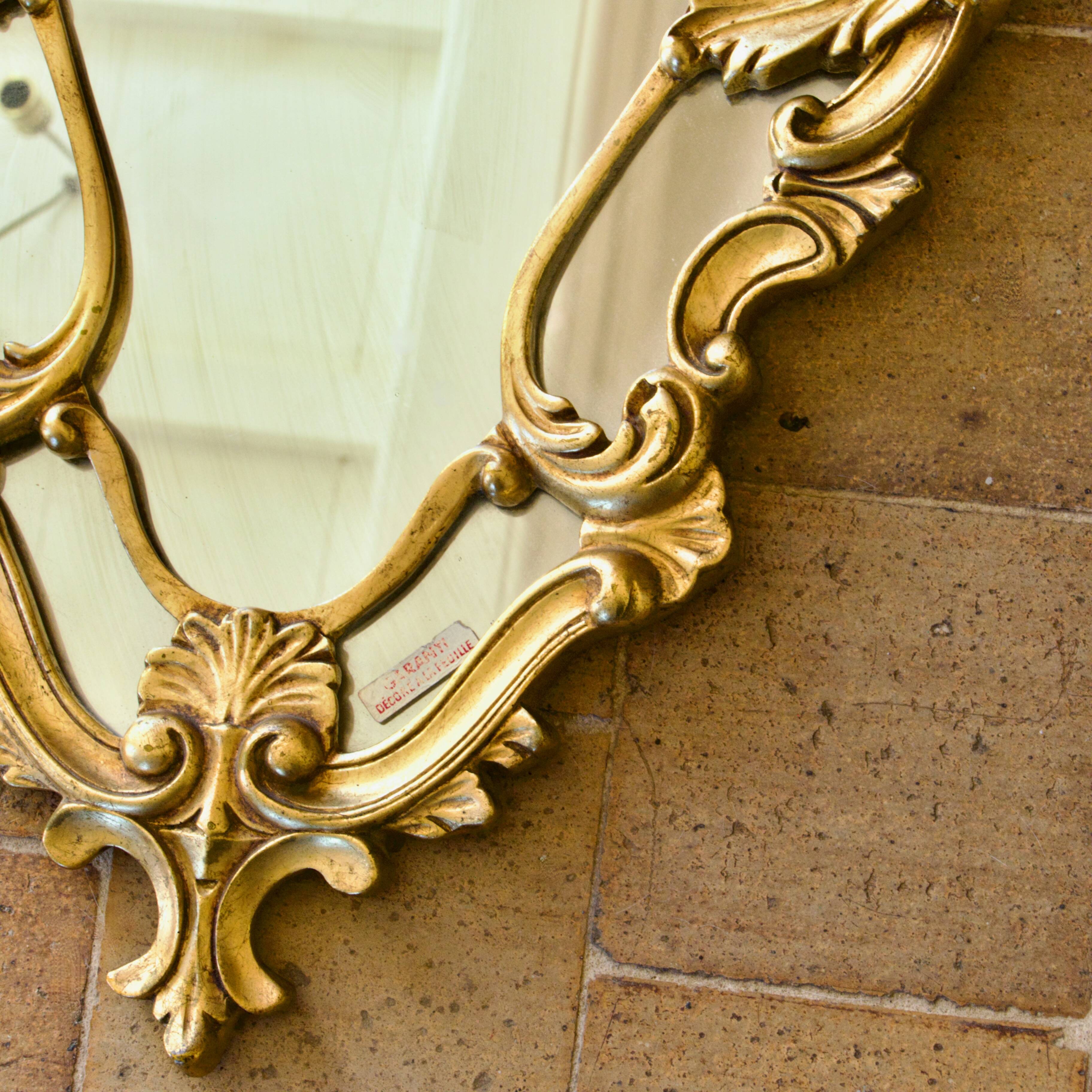 Antique Baroque mirror with gilded metal panels