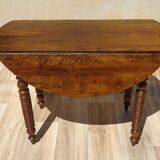 Antique walnut table with drop-leaf doors