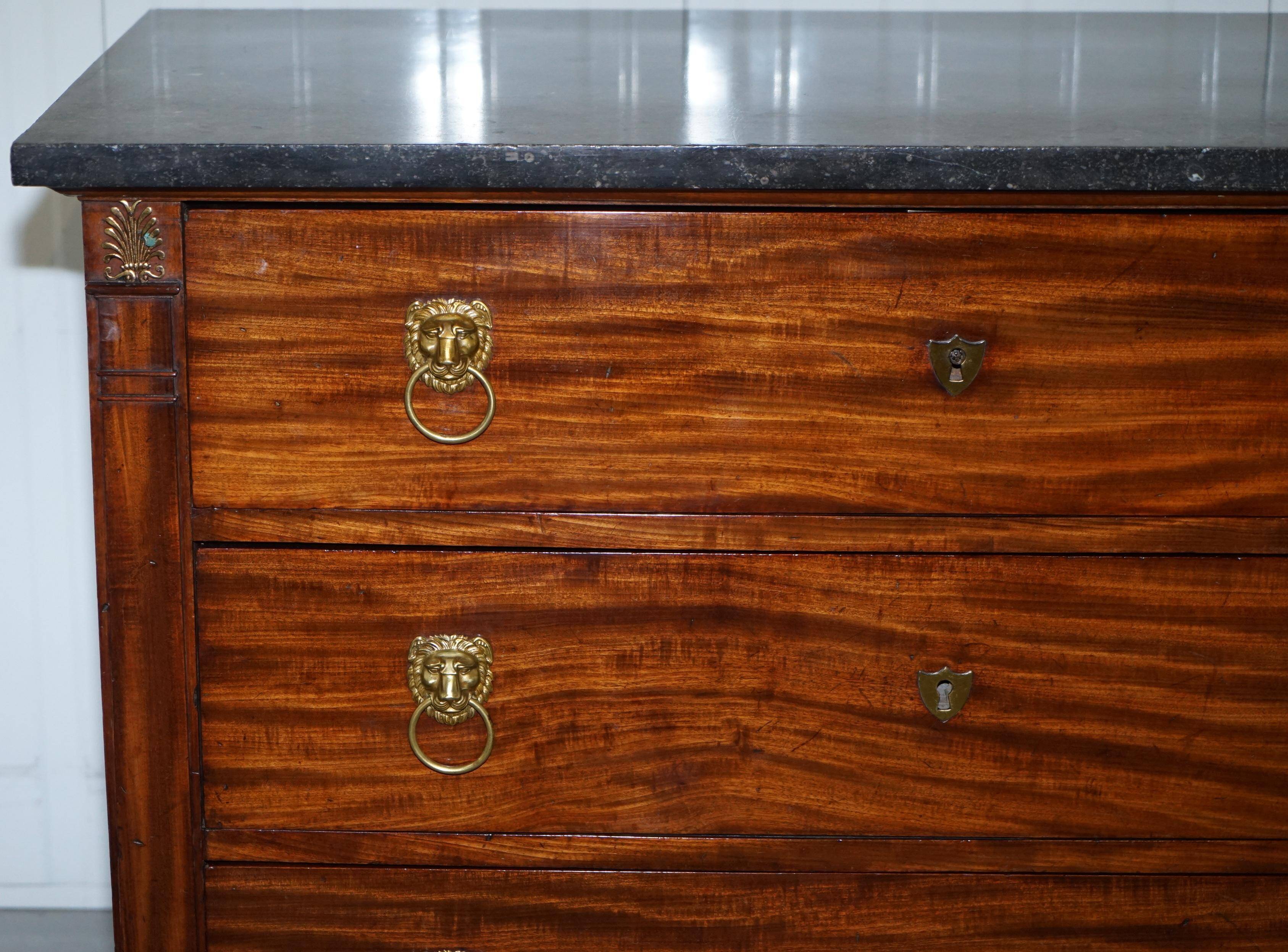 19th-century Empire commode with a marble top and lion paw feet.