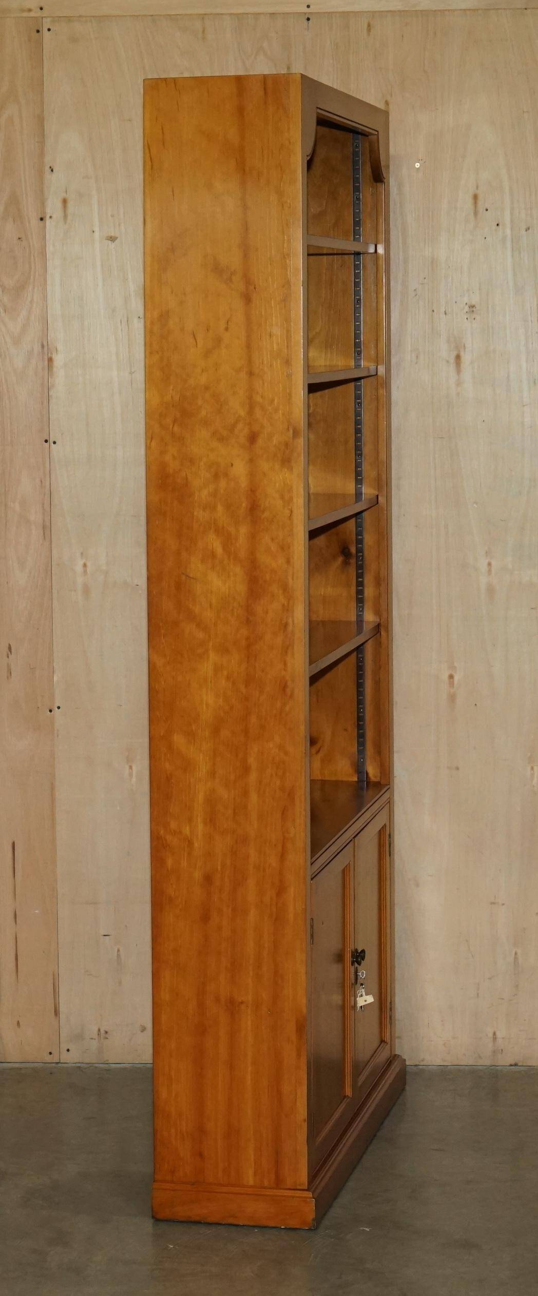 Pair of vintage cherry wood bookcases with lockable doors.