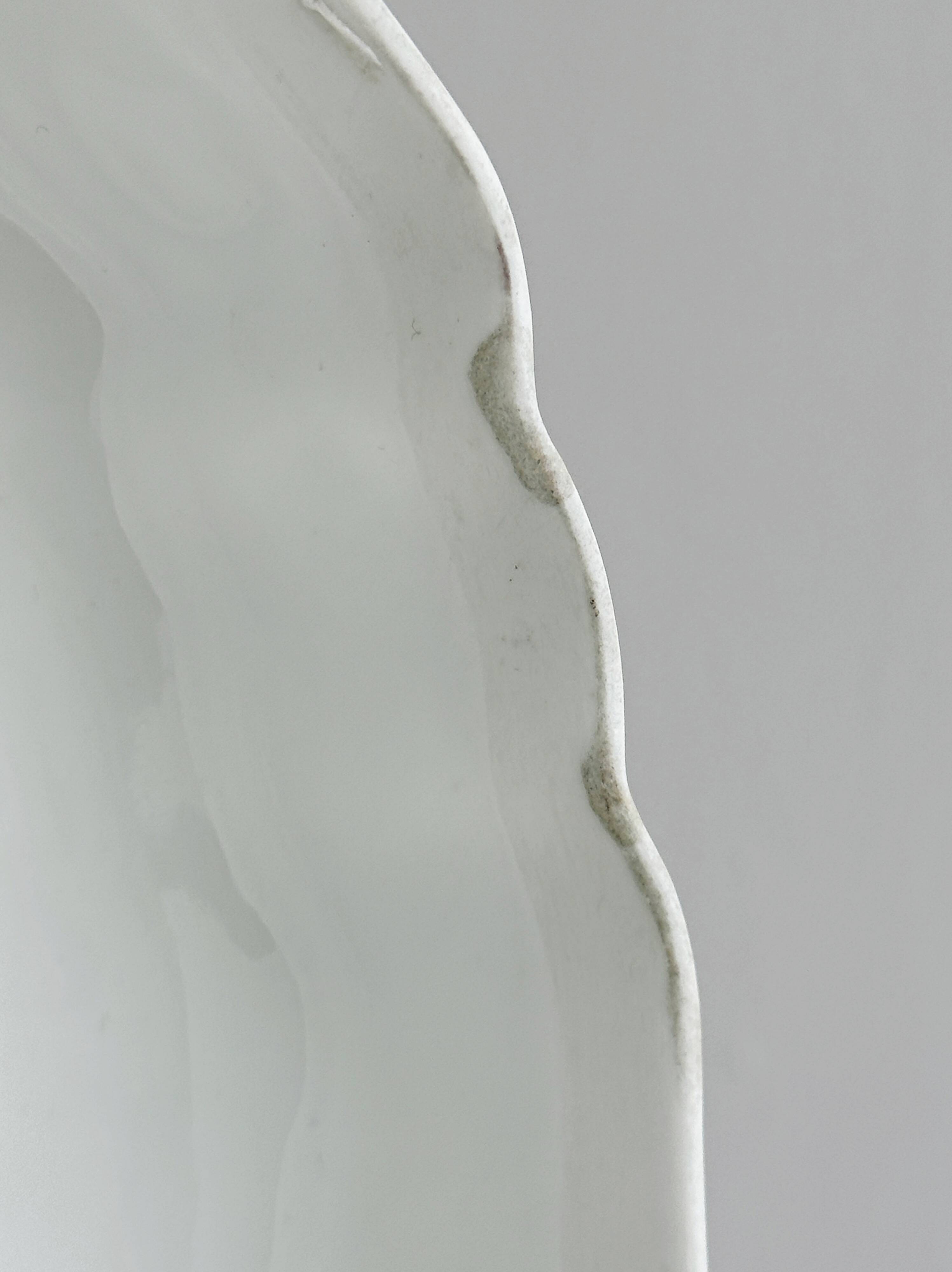 White fine porcelain soup tureen with relief decoration.