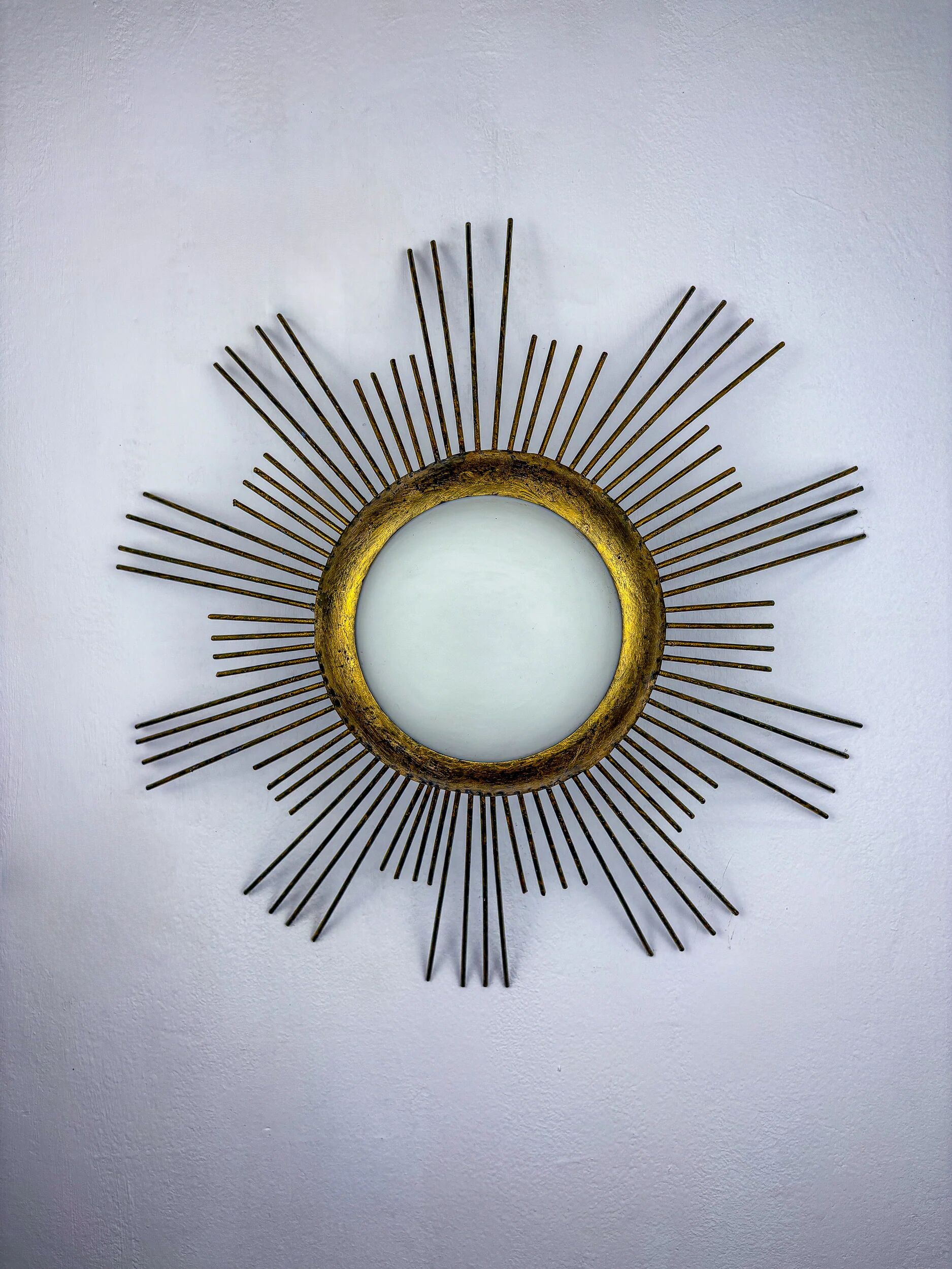 Large sunburst brutalist ceiling flush mount or pendant – gilt iron rays & opaline, France, 1950s