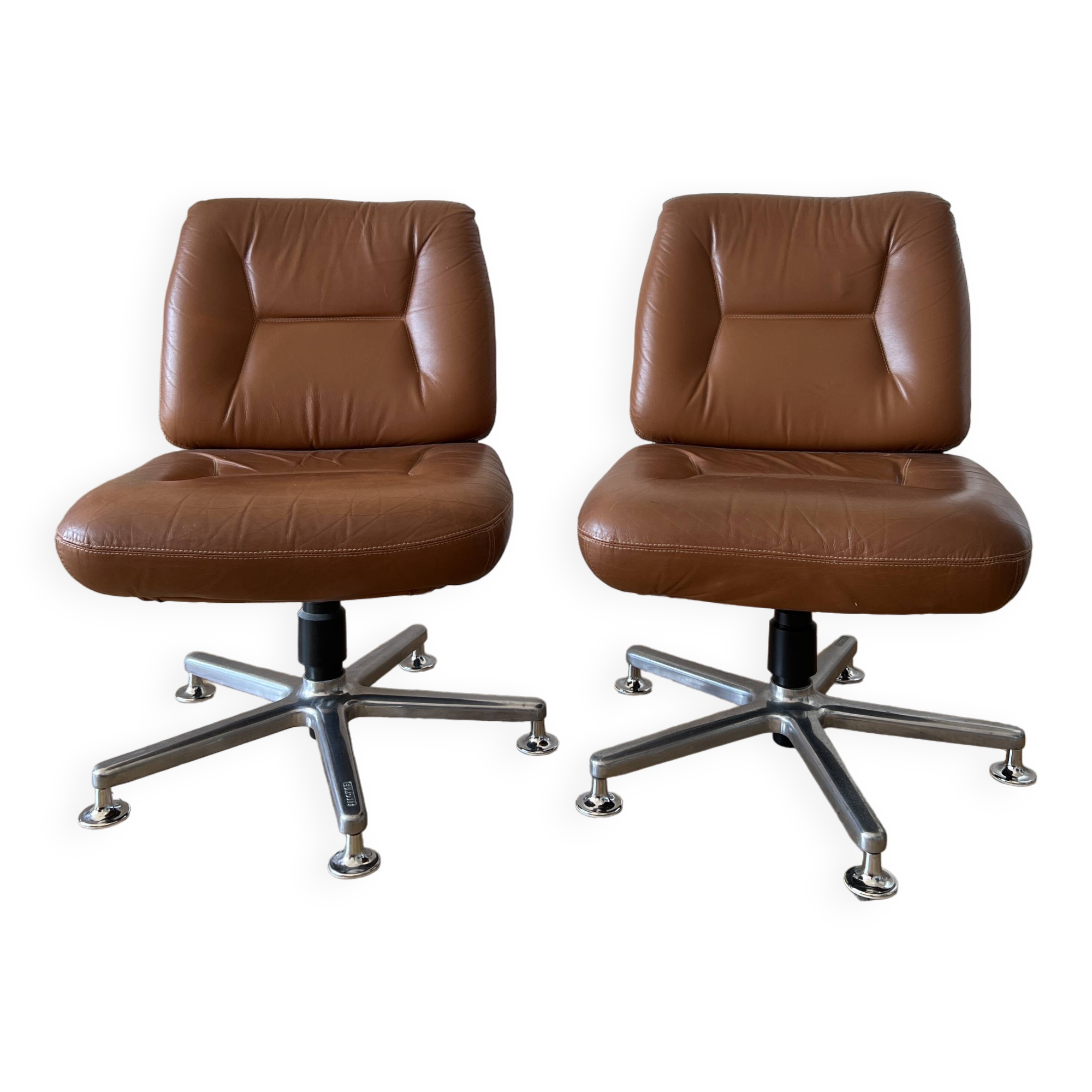 Pair of swivel armchairs in cognac colour.