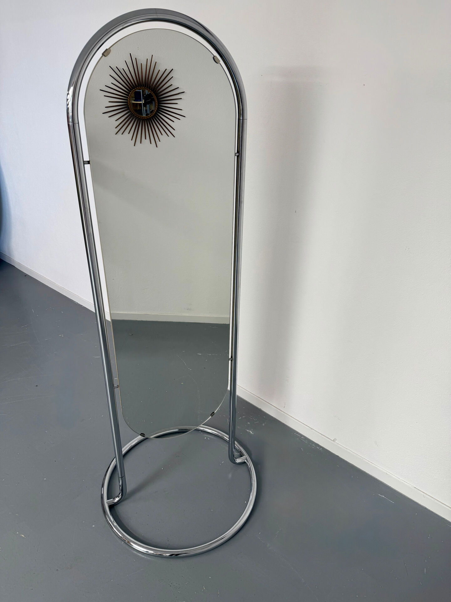 Large freestanding chrome metal full-length mirror in 1970s design.
