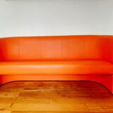 Curved vintage orange canapé with a pop spirit, seventies design piece.