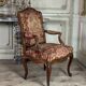 Louis XV armchair in carved walnut, needlepoint tapestry, 18th century