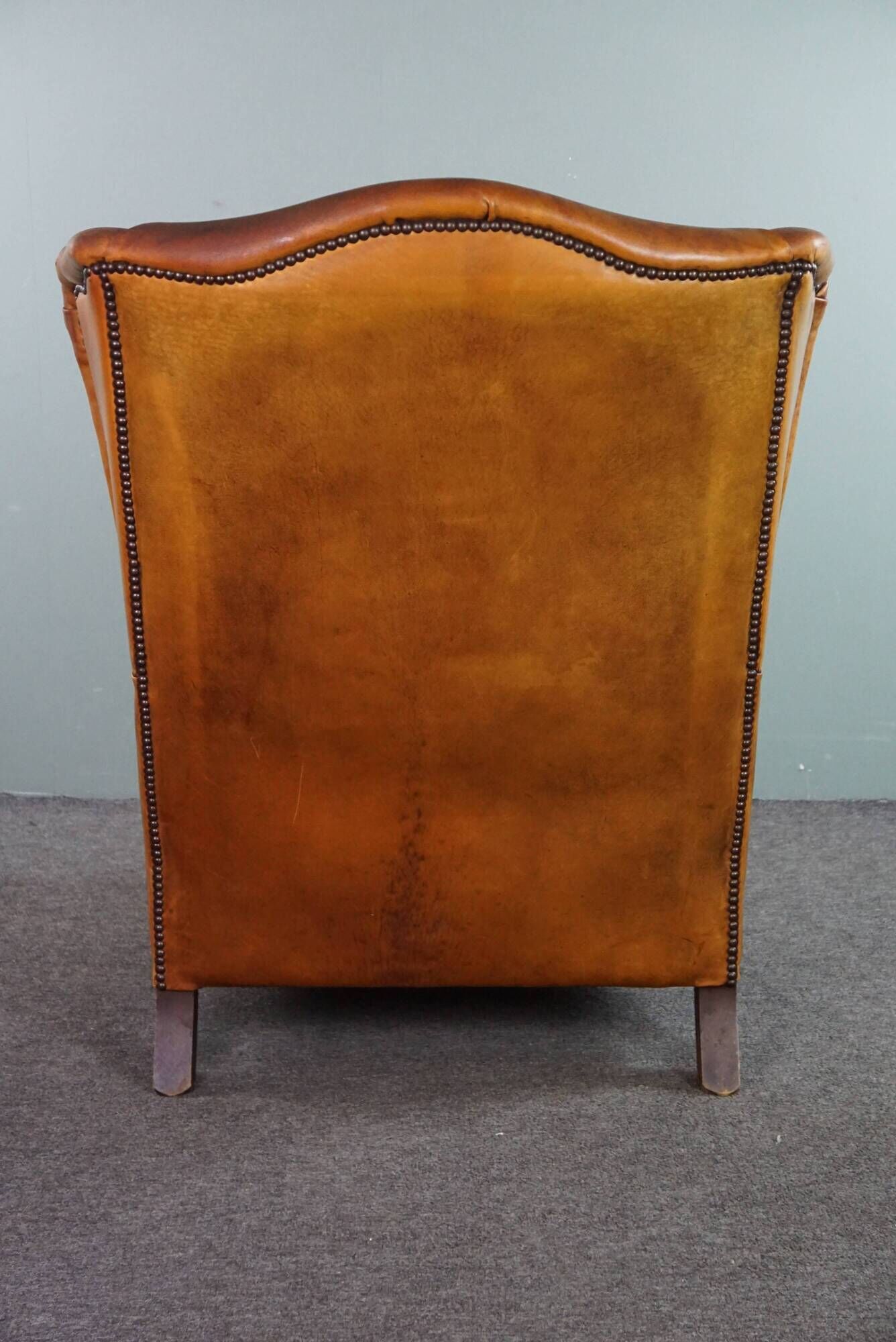 Wingback chair made of sheepskin leather in a light honey color