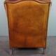 Wingback chair made of sheepskin leather in a light honey color