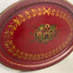 Old oval plate in painted red tin - floral decoration - early 20th century -