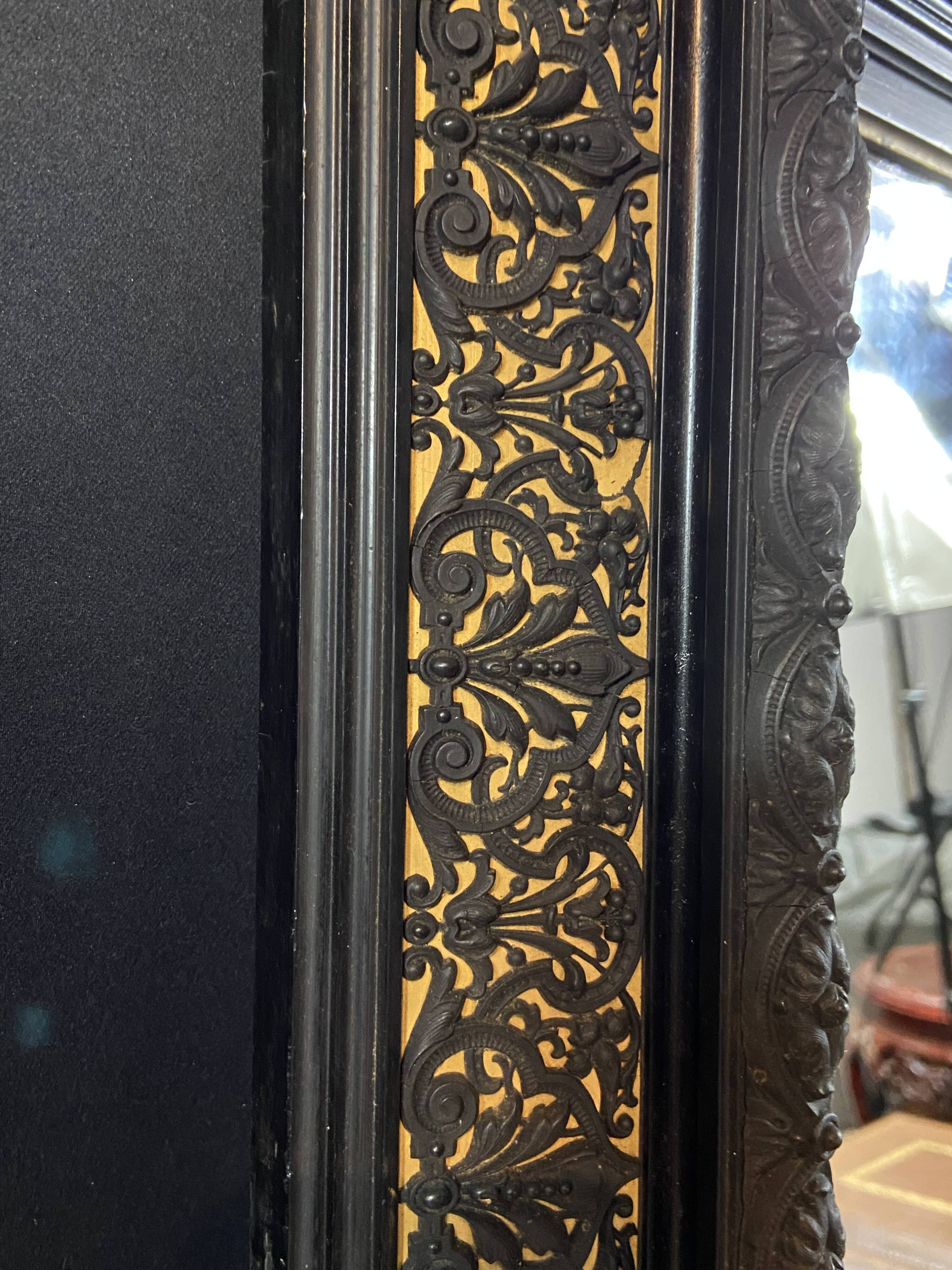 19th-century mirror Napoleon III in blackened wood on a gold background.
