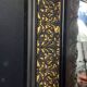 19th-century mirror Napoleon III in blackened wood on a gold background.