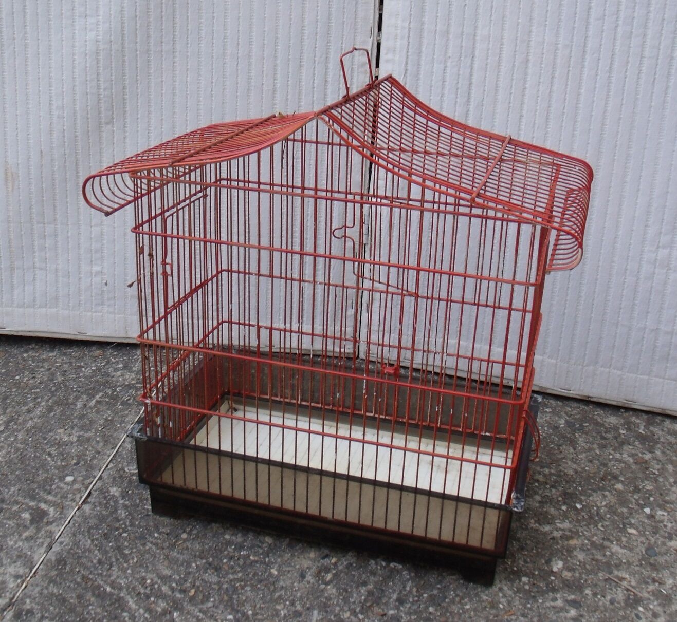 Old red metal birdcage