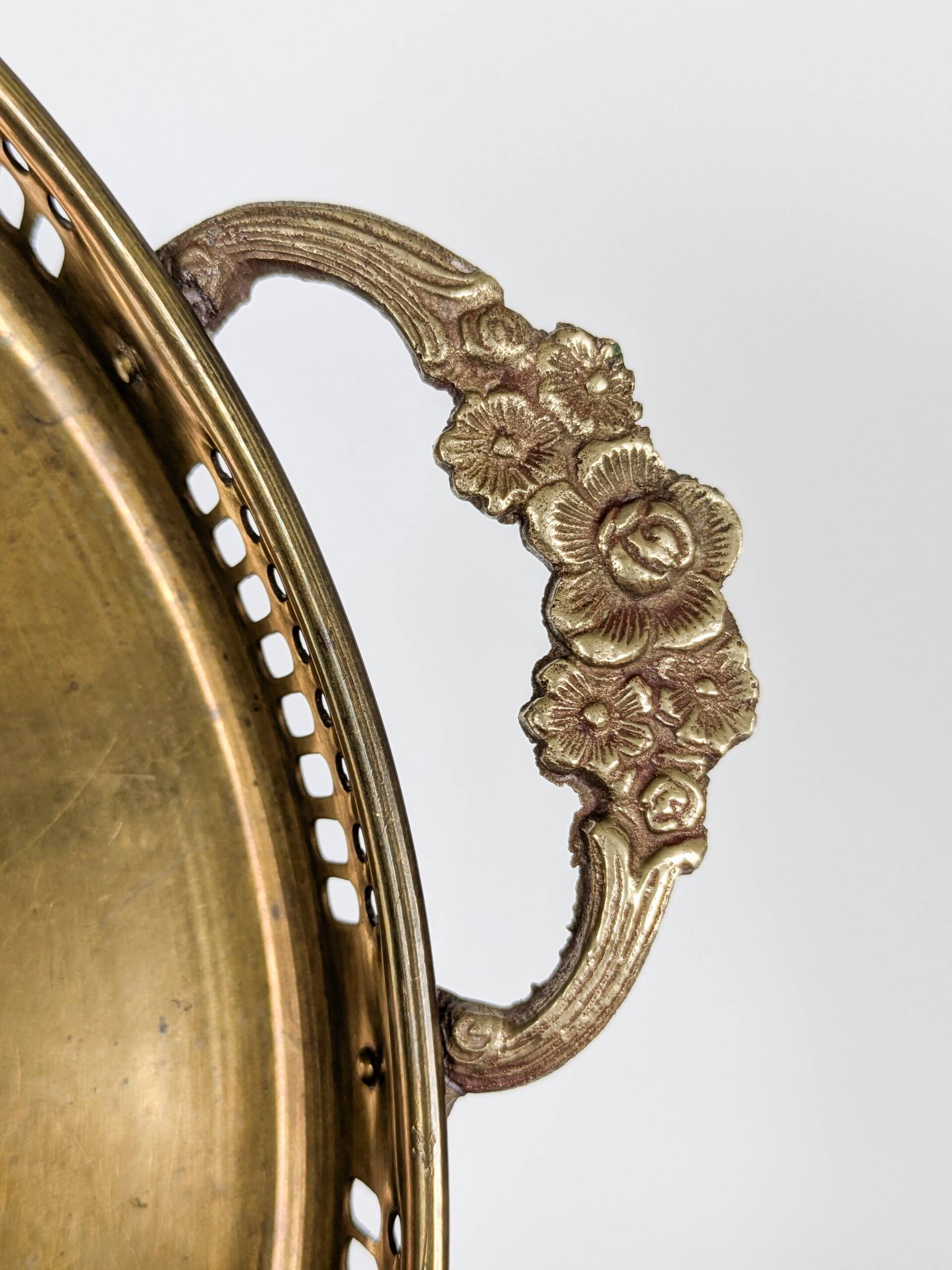 Vintage decorative brass tray, pierced edge and floral handles.