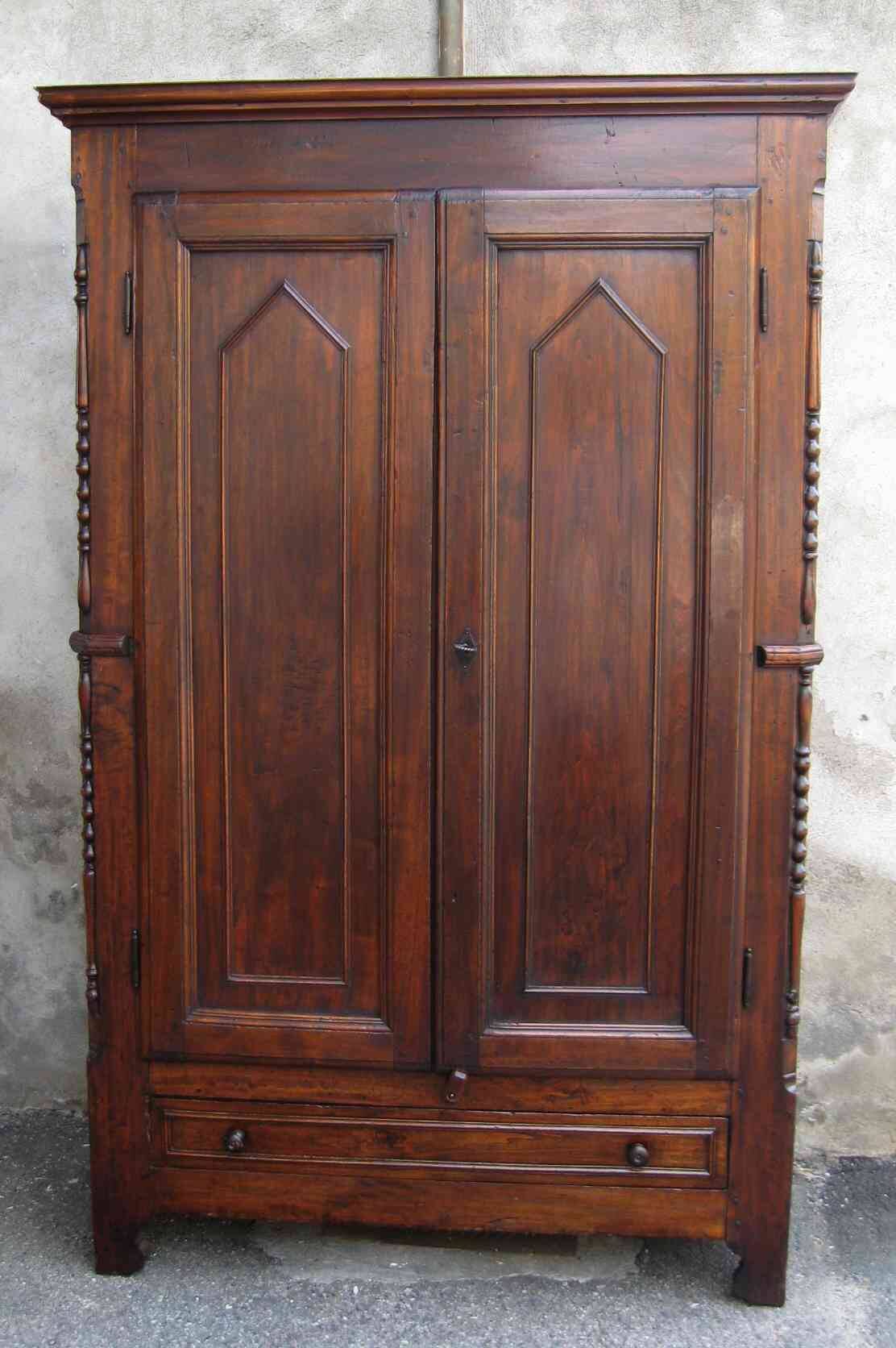 Antique solid wood wardrobe in historical rustic style from the 19th century.