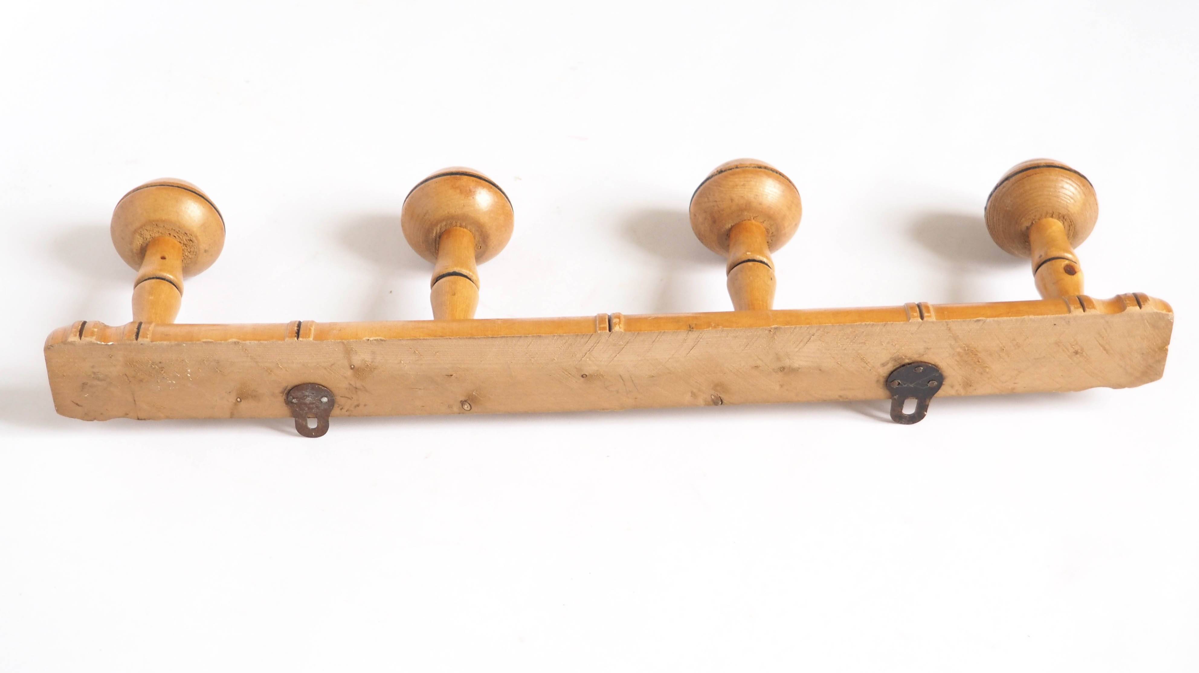 Light wood coat hooks 1900