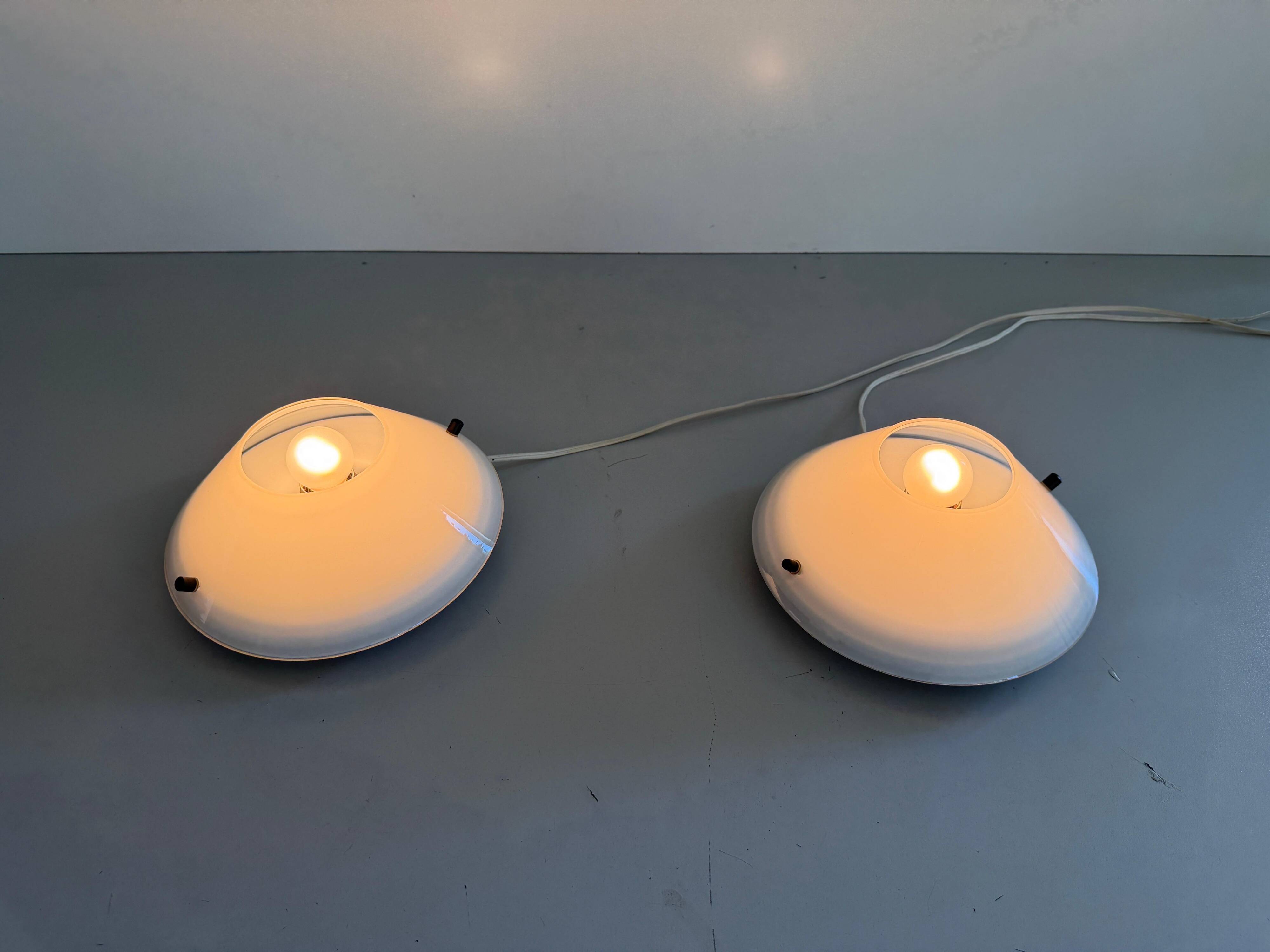 Pair of opal glass wall lights from the mid-century by Lamperti, 1960s, Italy.