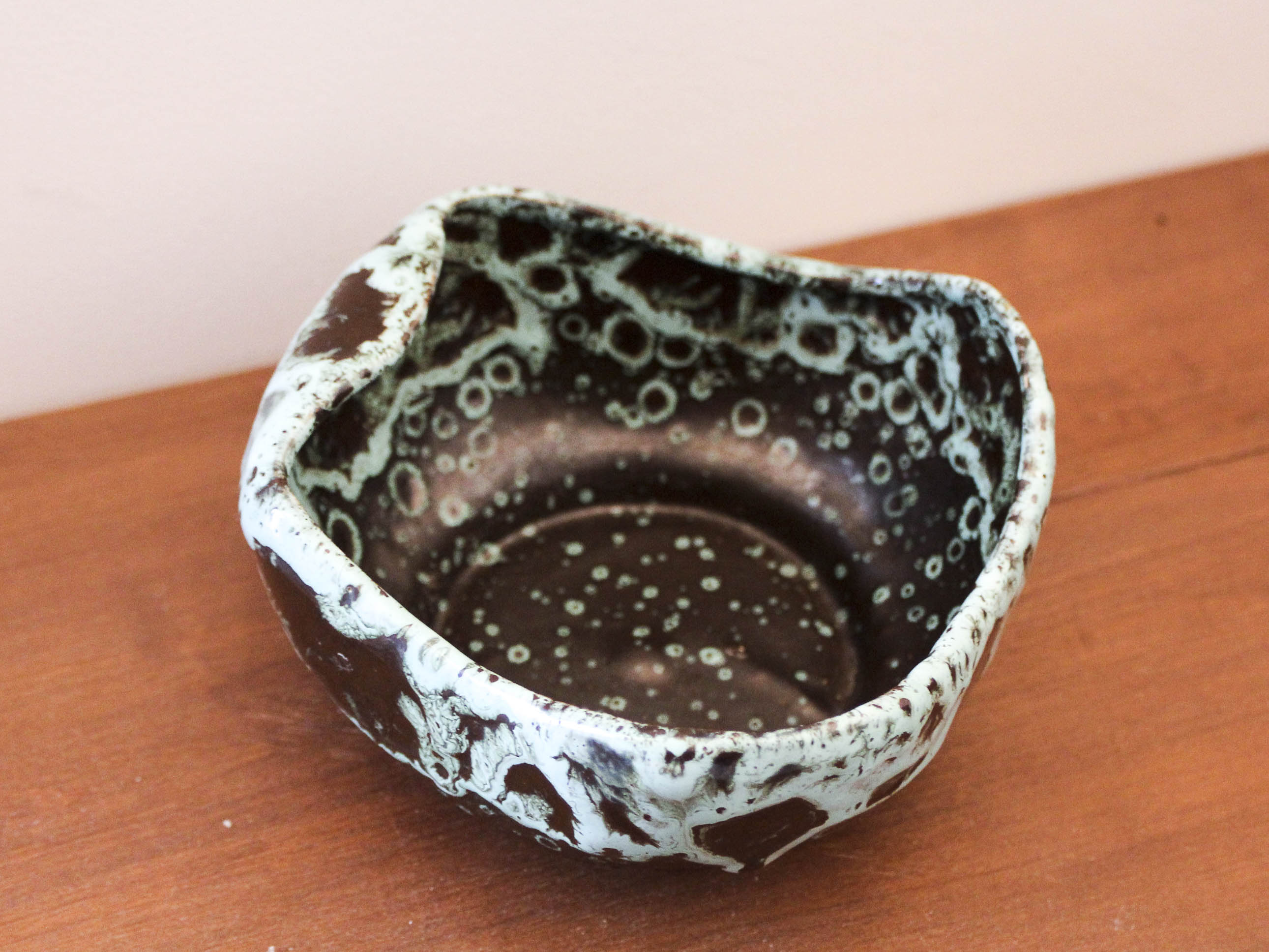 Empty pocket in black ceramic with green drip