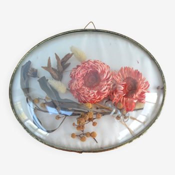 Medallion frame with dried flowers inside