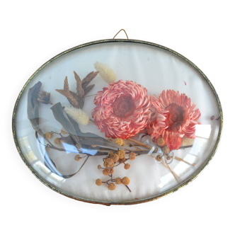 Medallion frame with dried flowers inside