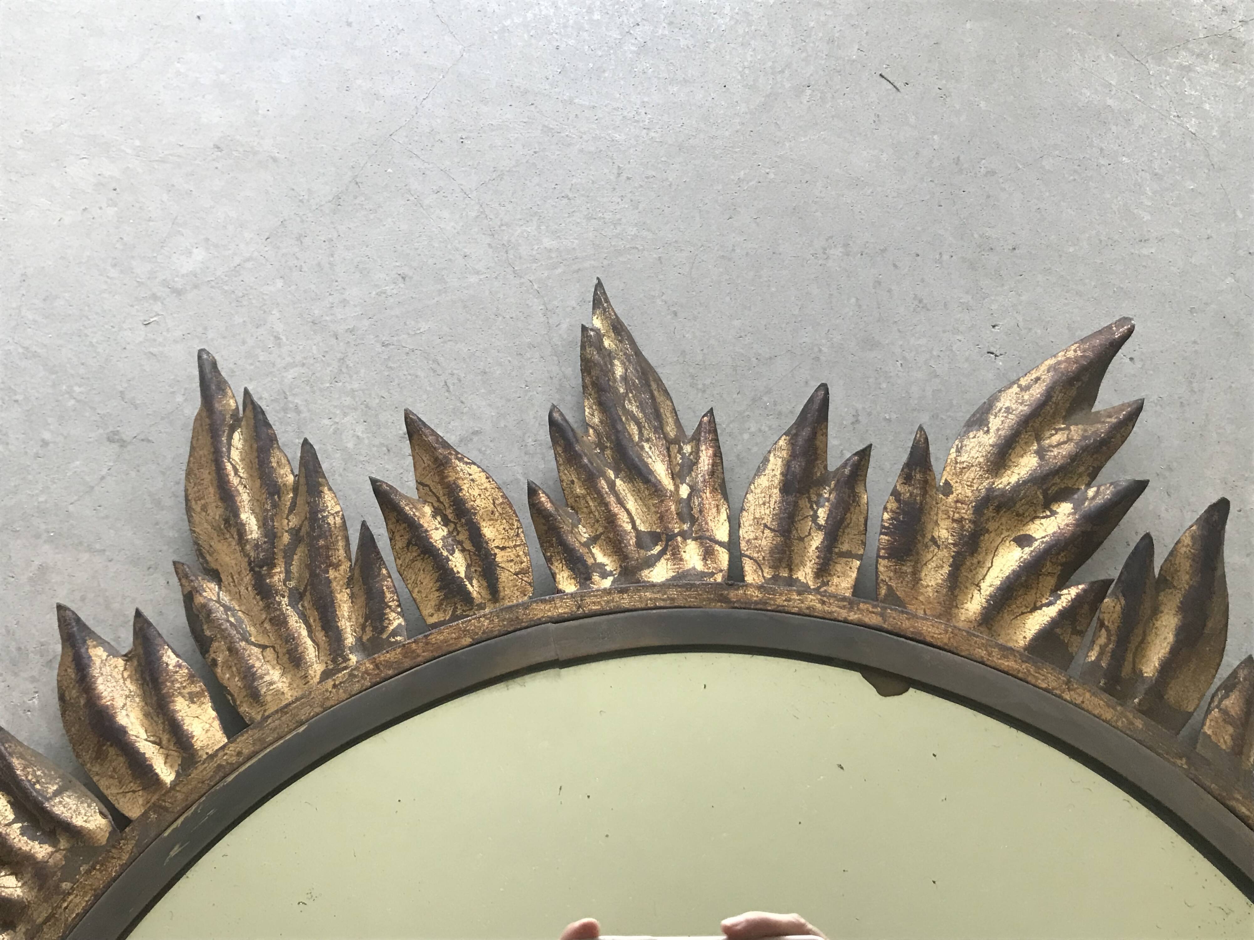 Sun mirror decorated with golden leaves, circa 1950.