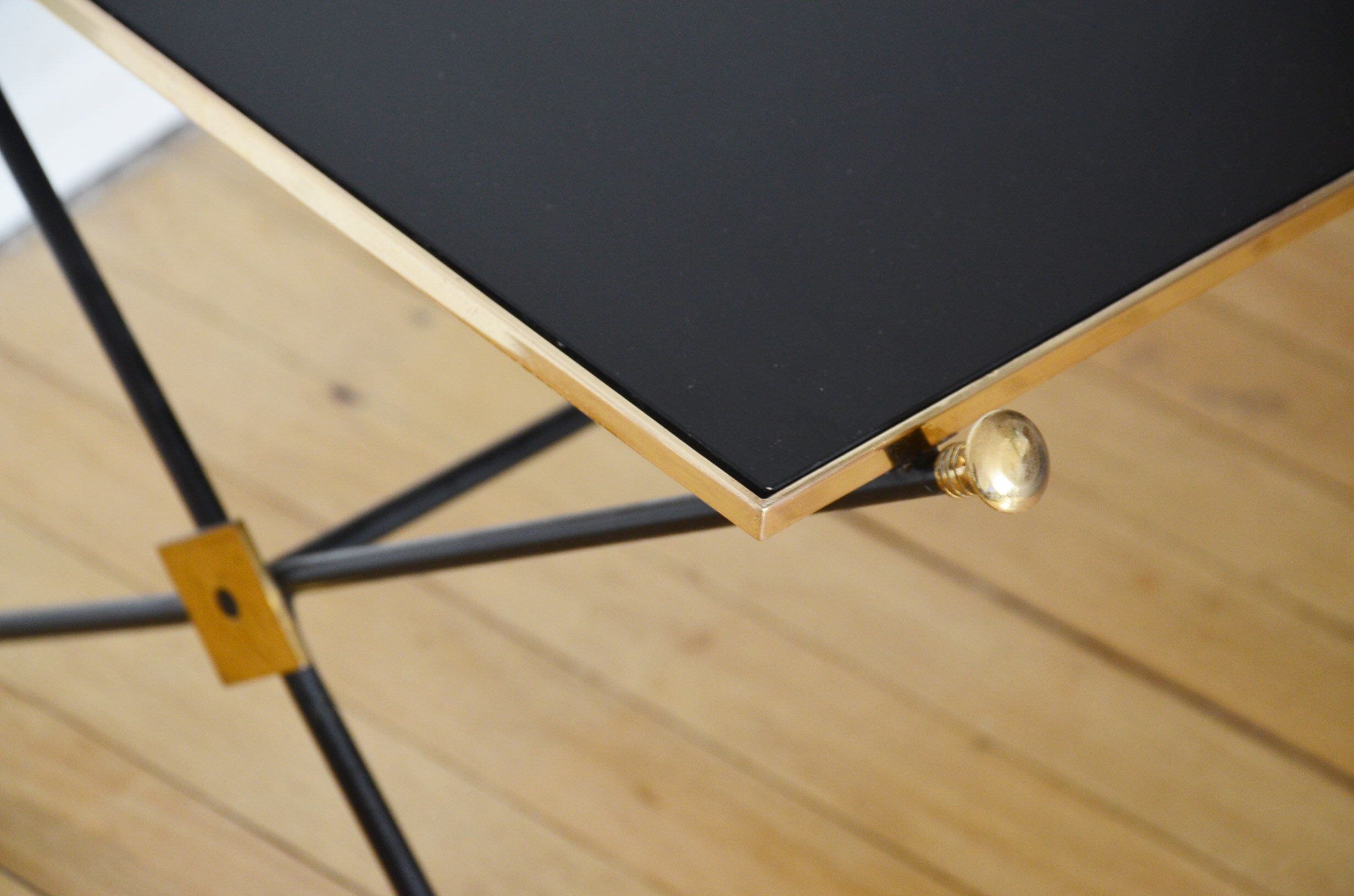 Black glass and brass coffee table in the 1960s