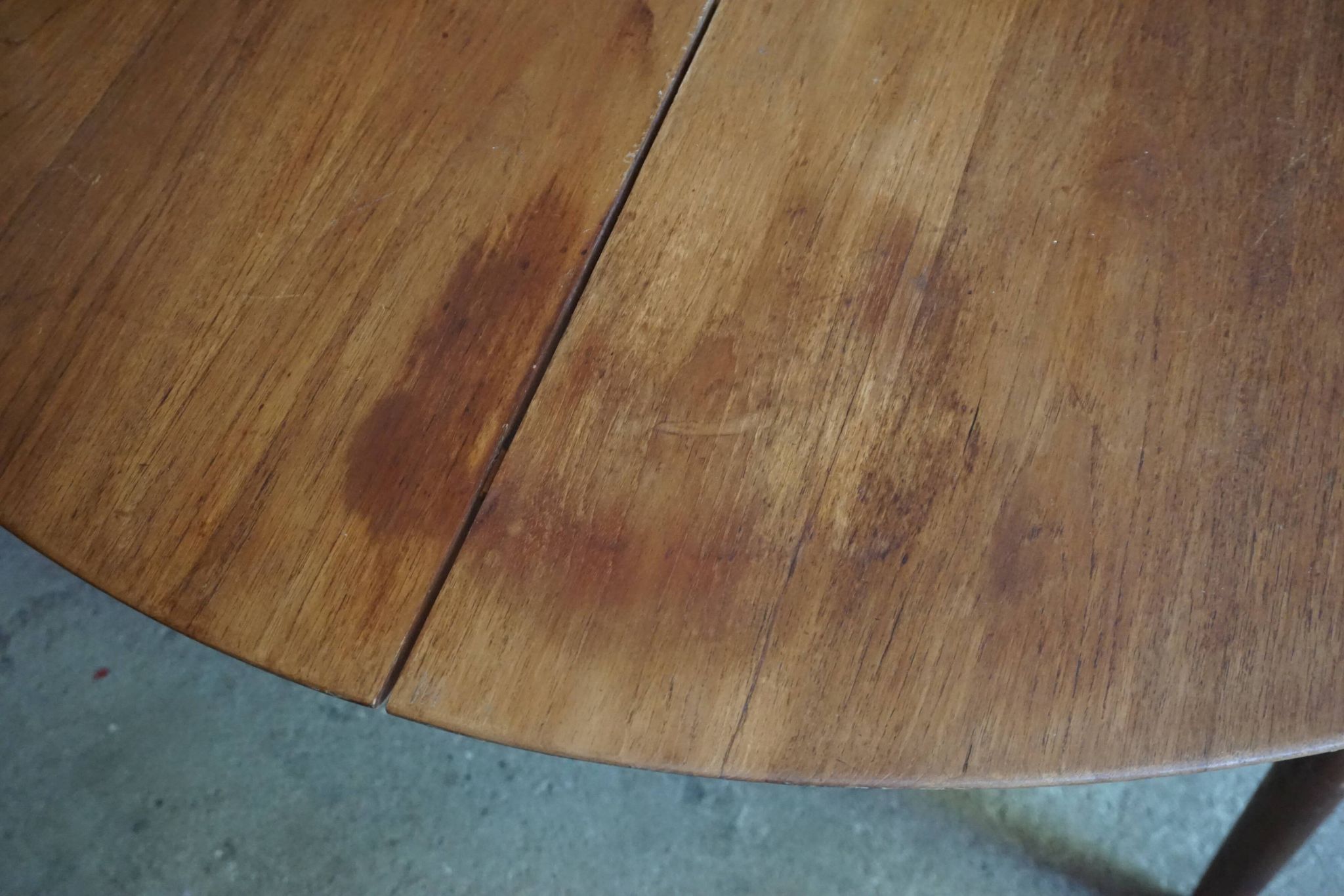 Elegant round teak table with extension.