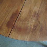 Elegant round teak table with extension.