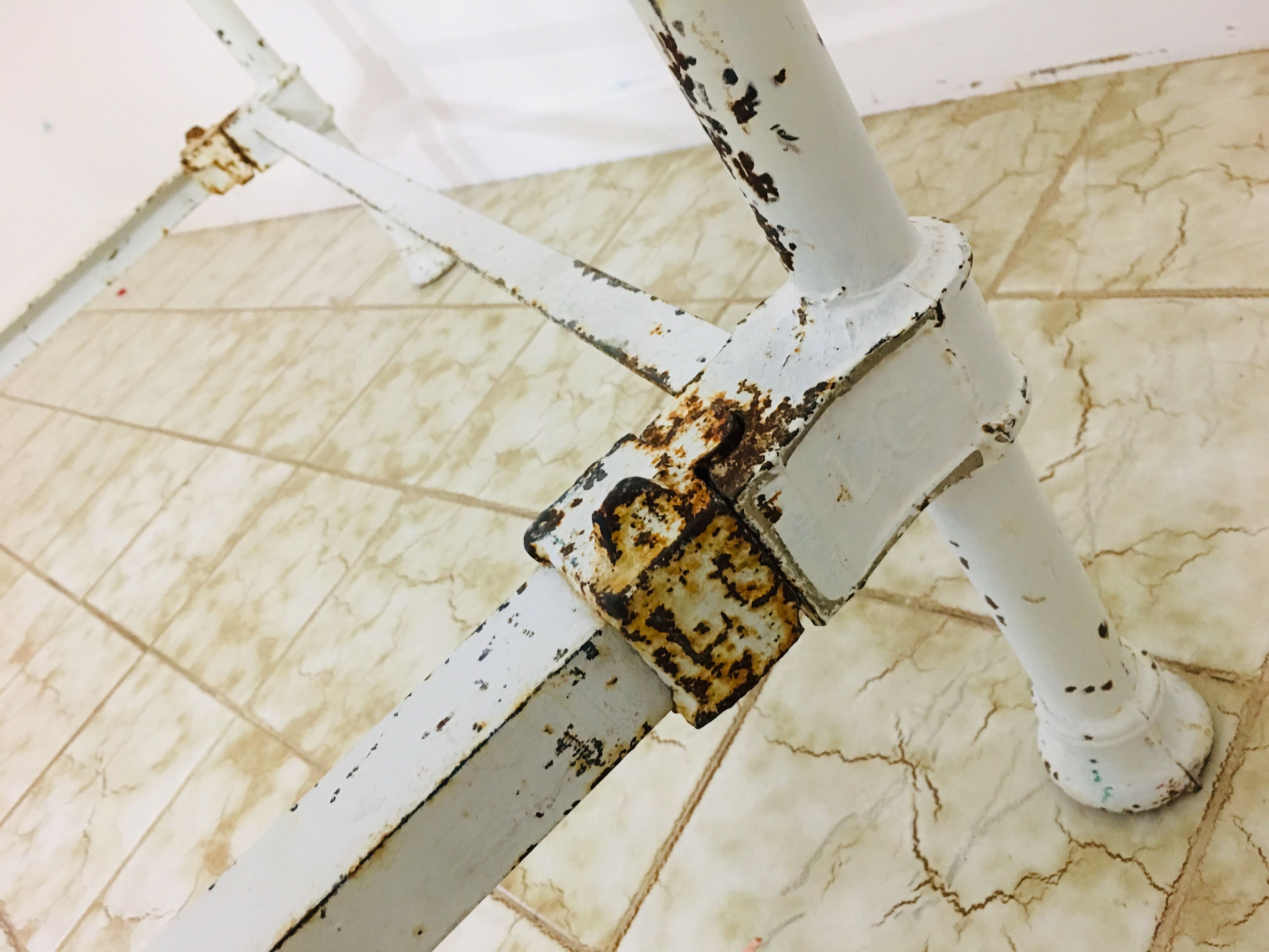 Old white metal and brass bed