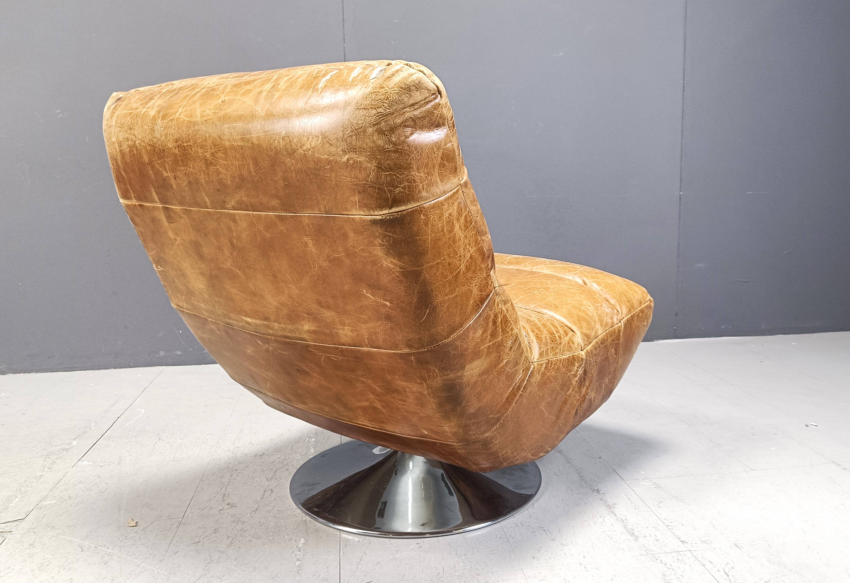 Vintage leather swivel chair with stool, 1970s
