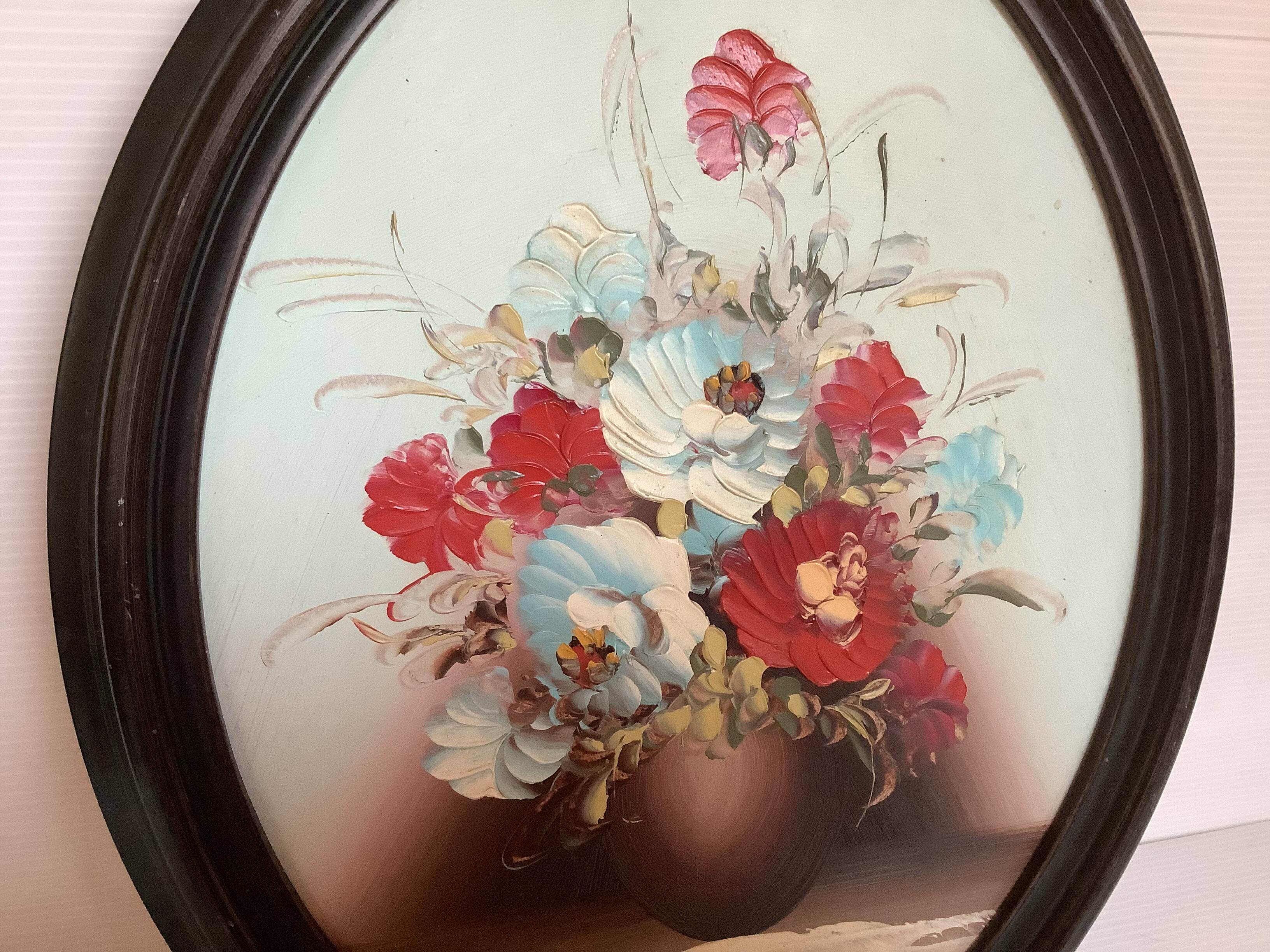 Oval painting of a bouquet of flowers, oil on panel.