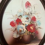 Oval painting of a bouquet of flowers, oil on panel.