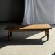 Brown Indonesian teak coffee table, with a border and cylindrical legs H40 L103.