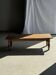 Brown Indonesian teak coffee table, with a border and cylindrical legs H40 L103.