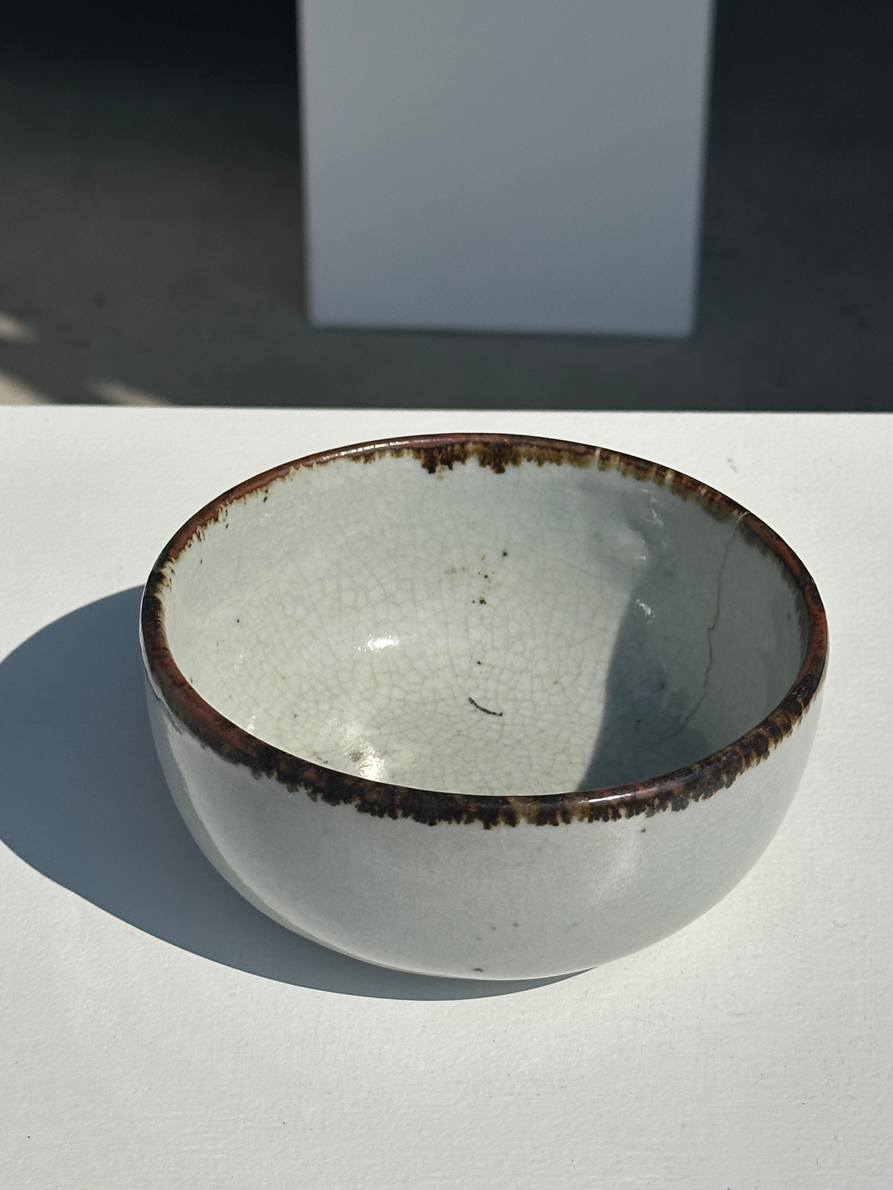Small white glazed ceramic bowl black edges