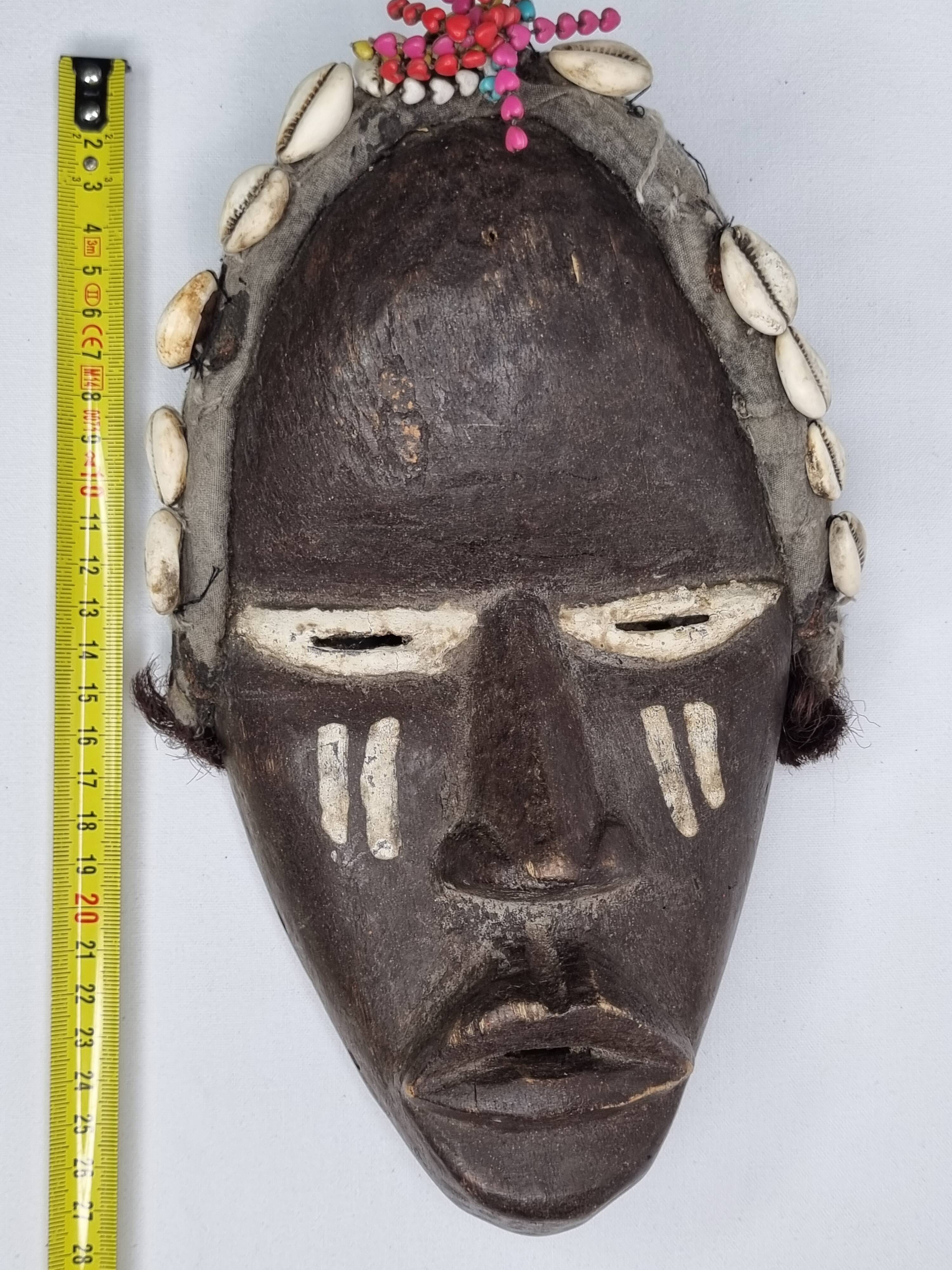 Tribal Dan mask in wood and cowrie shells, West Africa, 27 cm