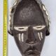 Tribal Dan mask in wood and cowrie shells, West Africa, 27 cm