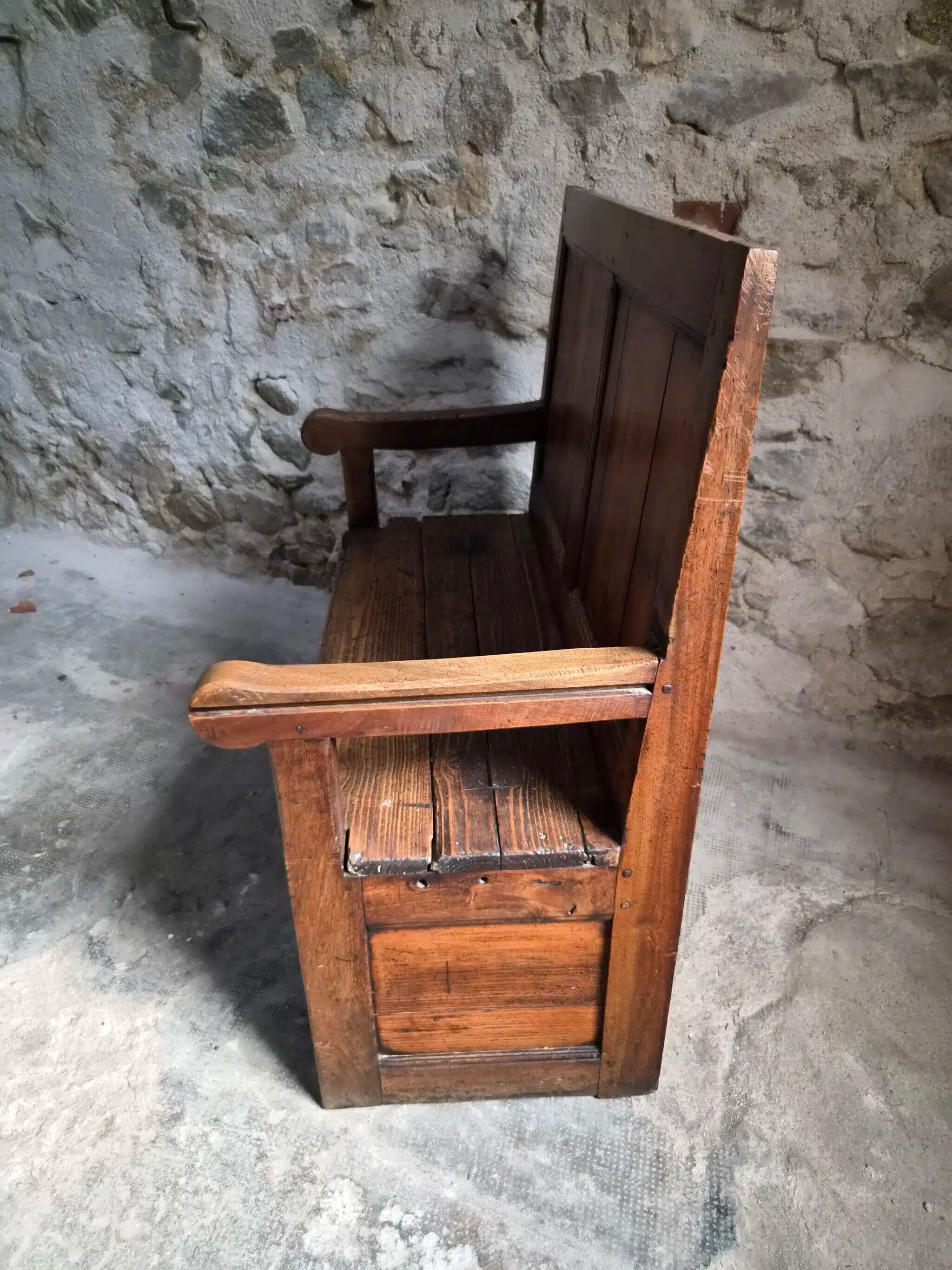 Rustic French antique storage bench from the 18th century in walnut and pine.